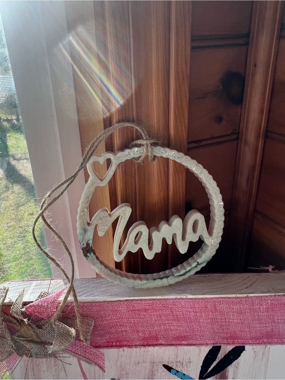 White featuring multi color “Mama” Hanging Ornament perfect for Mother’s Day !